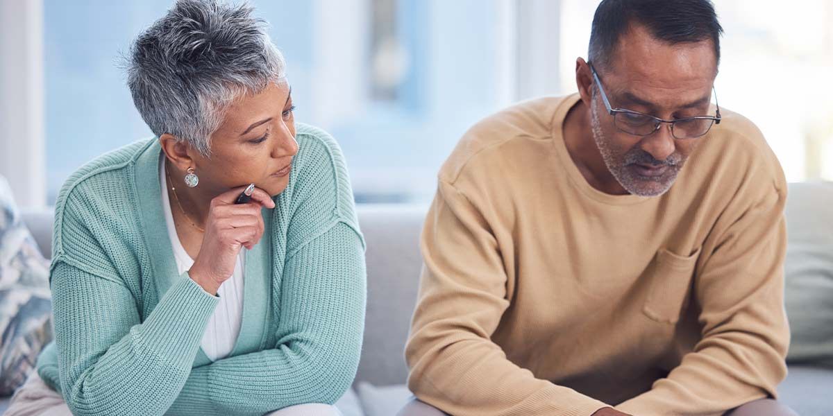 husband and wife reading a medical bill