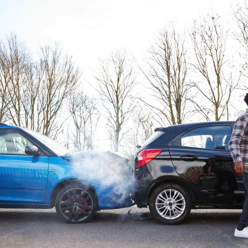 a man standing next to a blue car with its door open