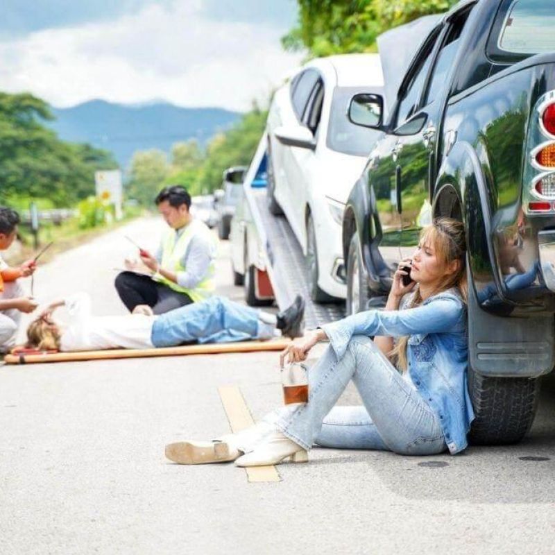 Woman by car after accident in Michigan.