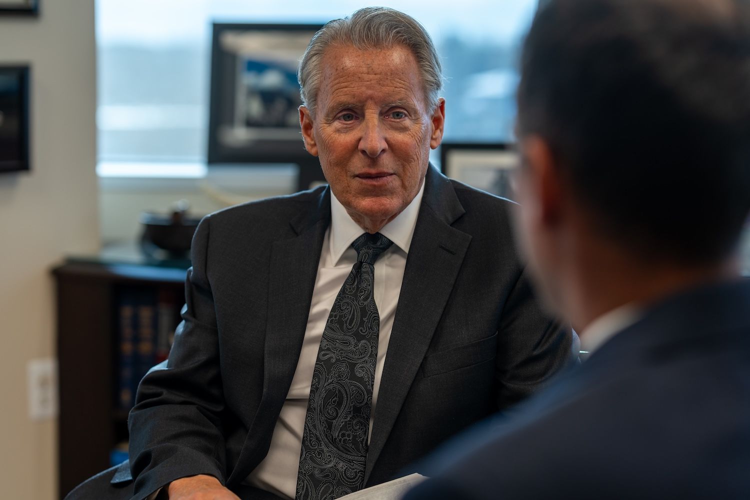 Two businessmen in a formal meeting discussing key decisions in a modern office setting.