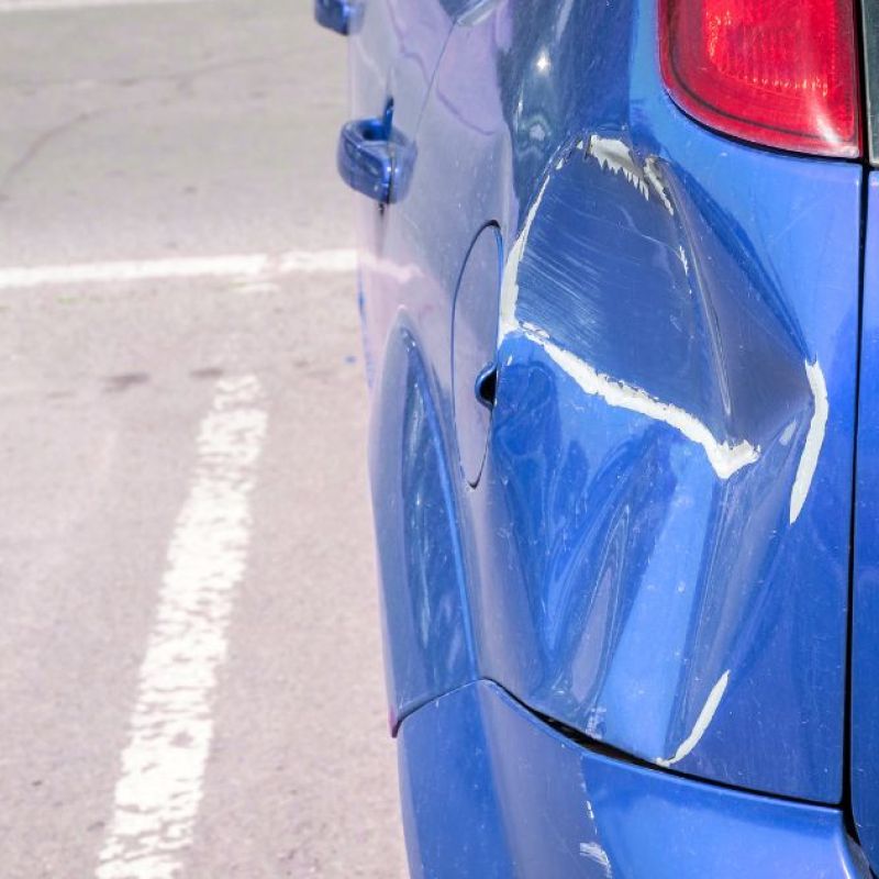 Car in a parking space with rear end damage