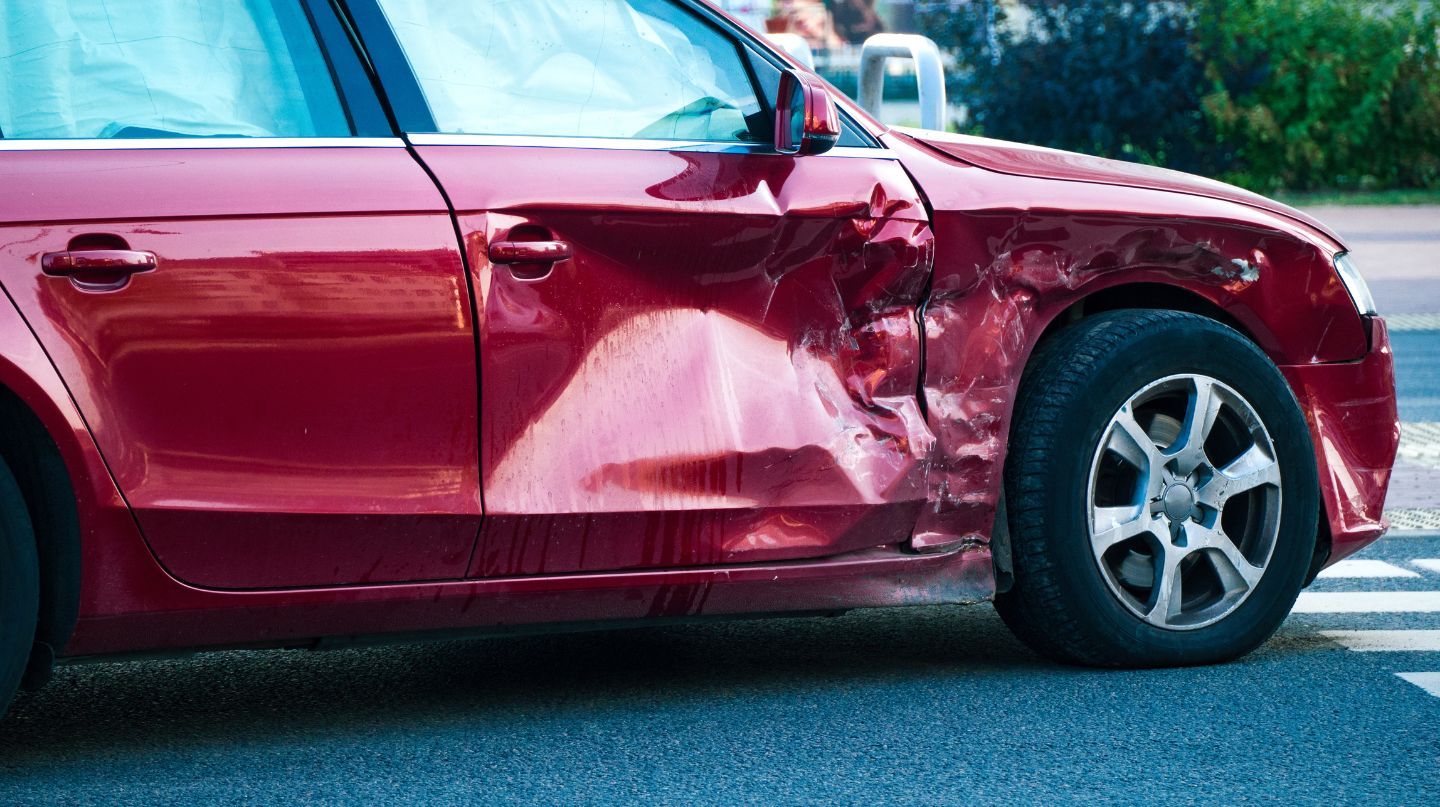 Red sudan hit in the side quarter panel