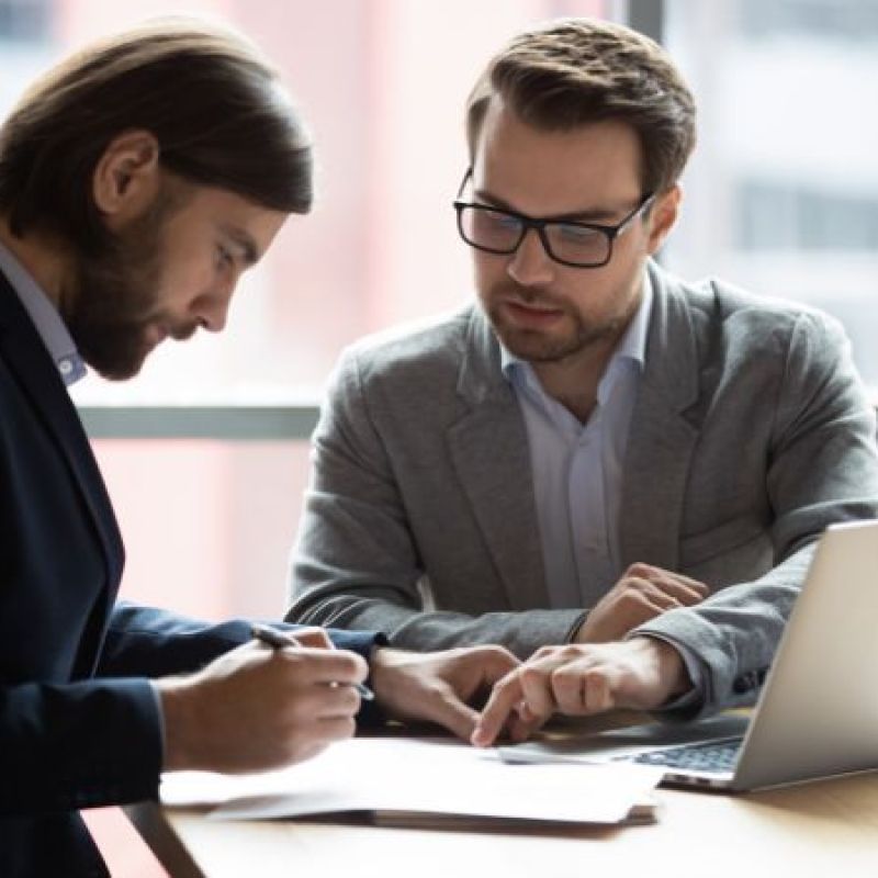 lawyer having a client sign paperwork