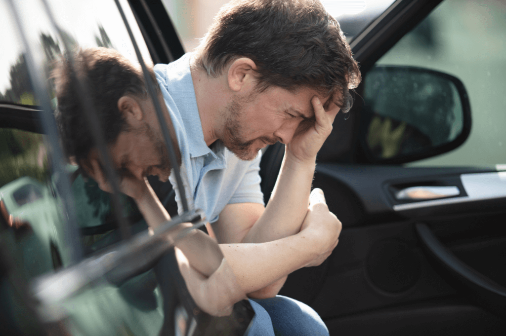 Man holding his head after head trauma from car accident