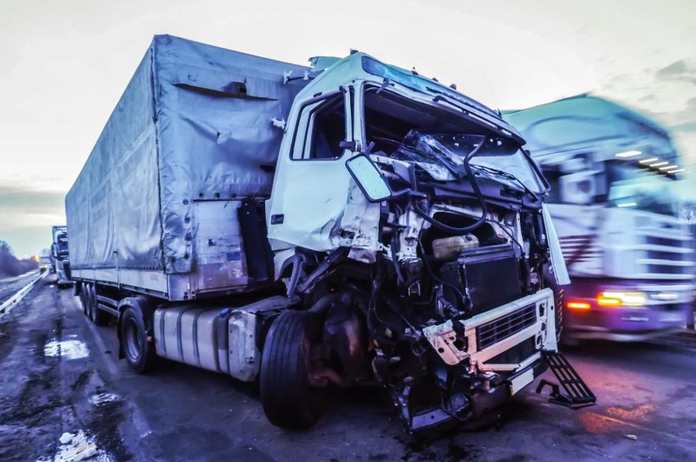 semi truck in road with front end damage