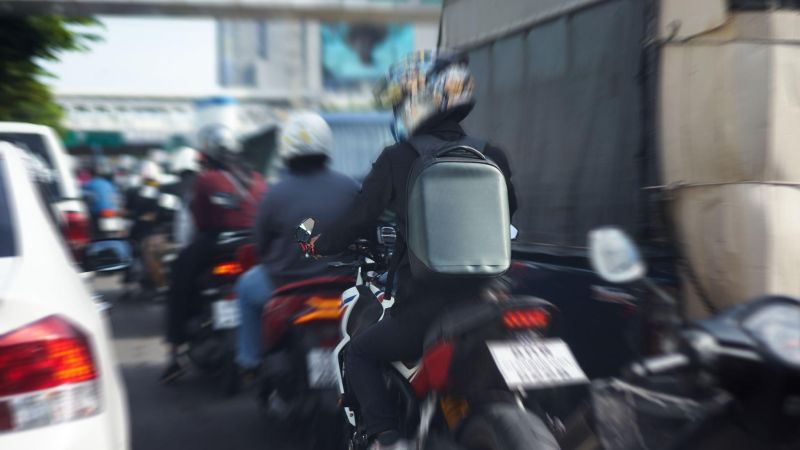 Motorcyclists riding on a street,