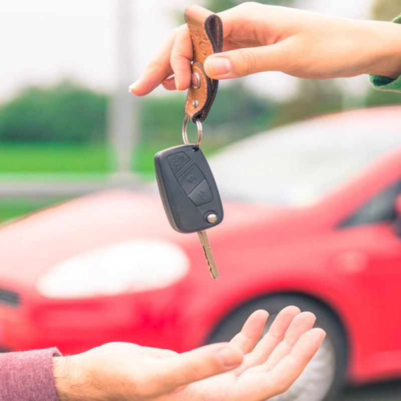 Woman handing her car keys to her friend