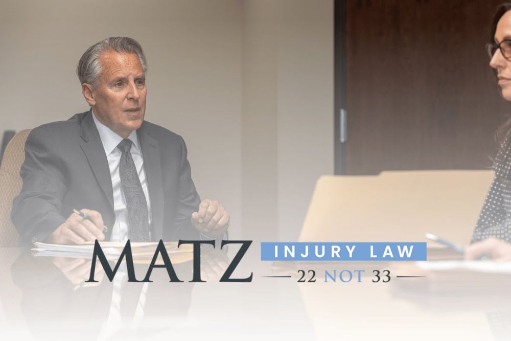 Lawyers discussing a case at Matz Injury Law office. Call 22 NOT 33 for legal assistance.