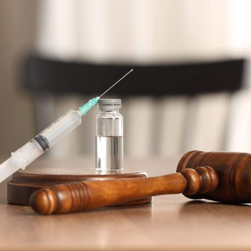 a wooden judge's gaven with a syringe on top of it