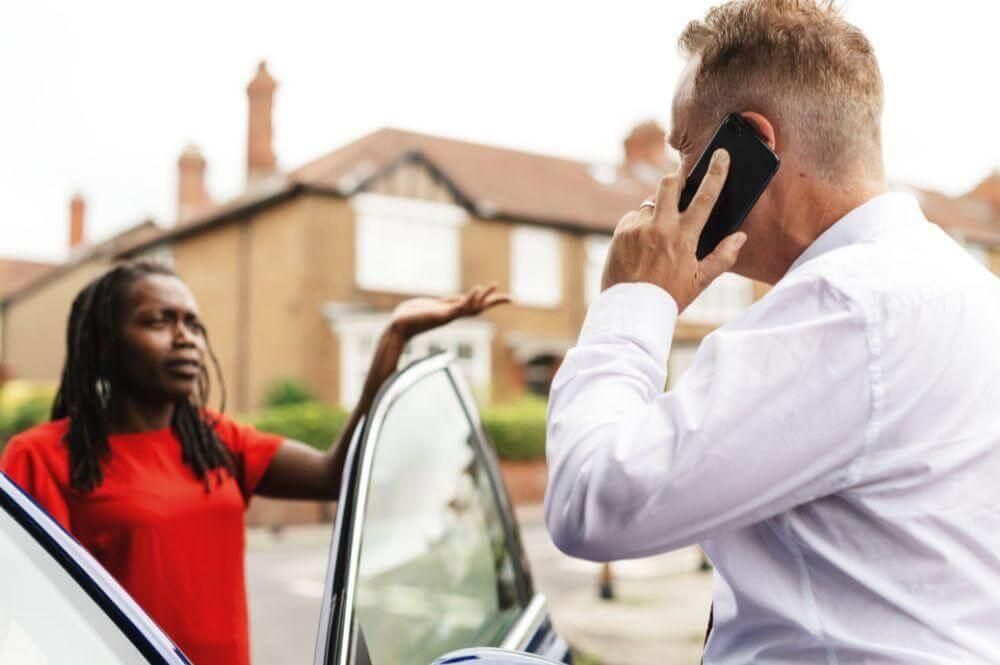 Man on cell phone next to woman,