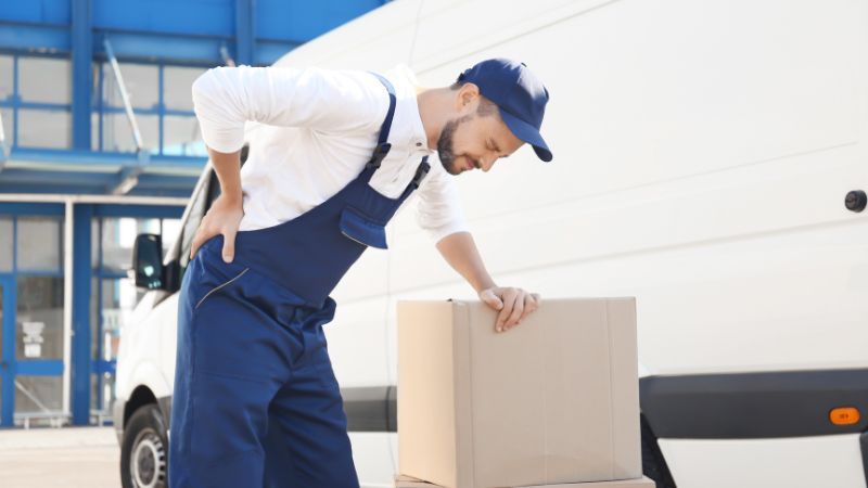 Postal worker holding his back in pain
