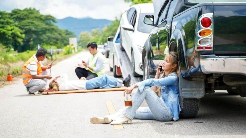 Woman by car after accident in Michigan.