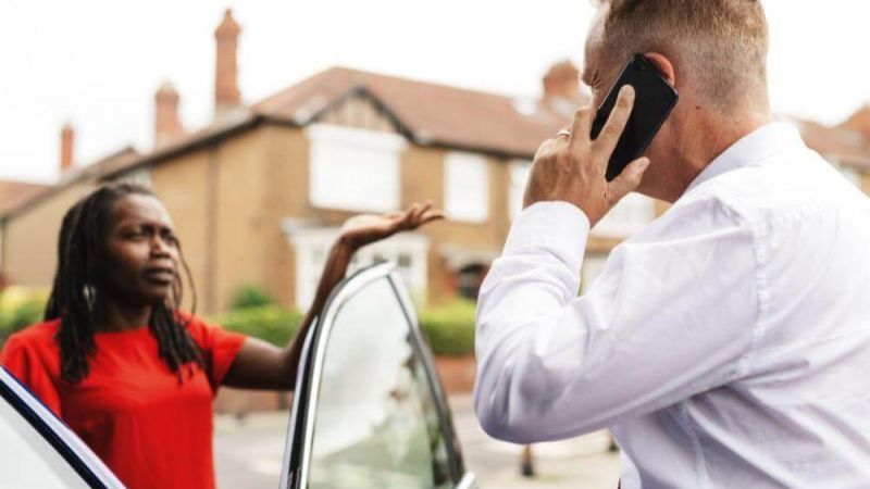 Man on cell phone next to woman,