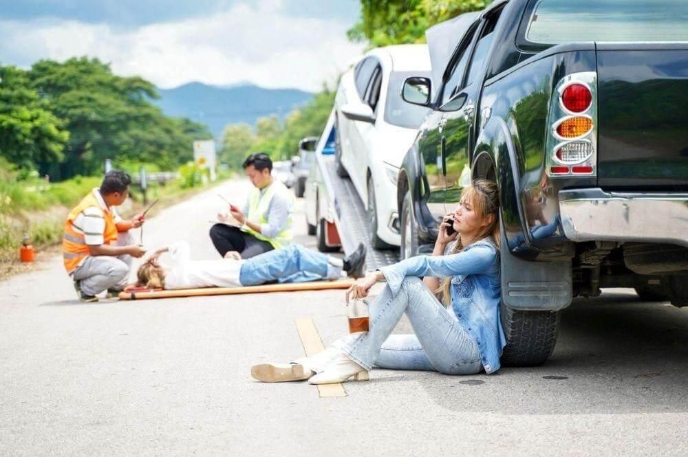 Woman by car after accident in Michigan.
