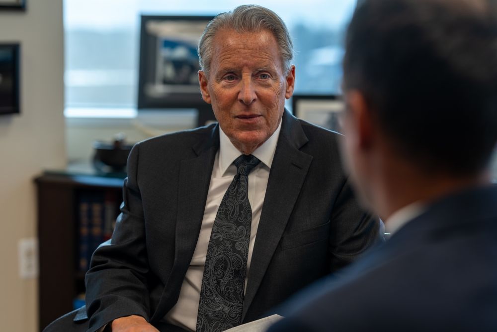 Businessman in a suit engaged in a professional discussion in an office setting.