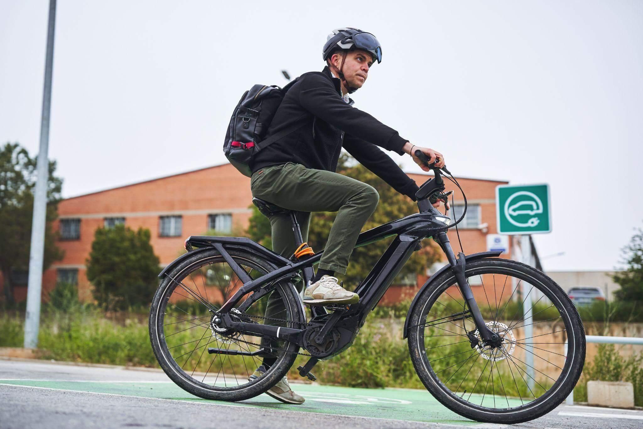 a man riding a bike down a street