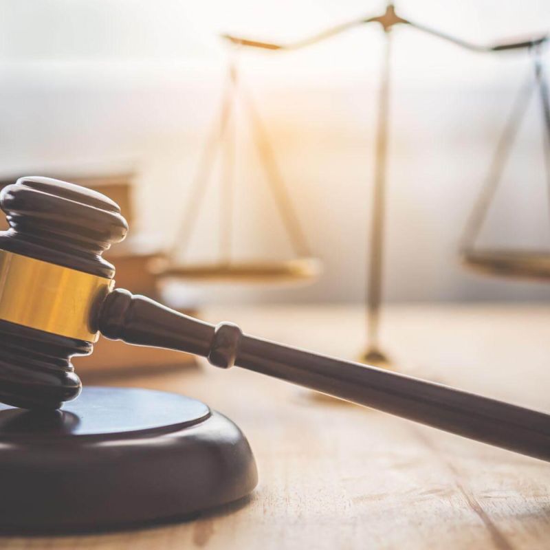 Judge's gavel on wooden table