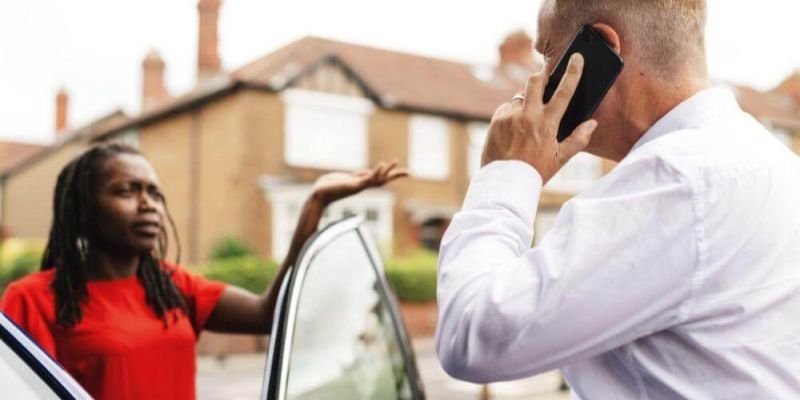 Man on cell phone next to woman,