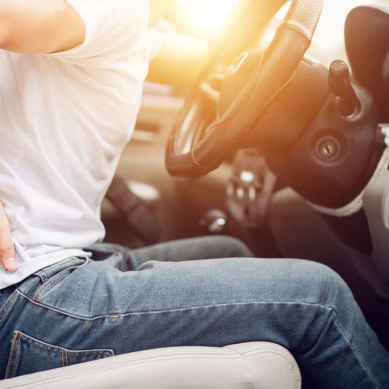 a man sitting in the drivers seat of a car