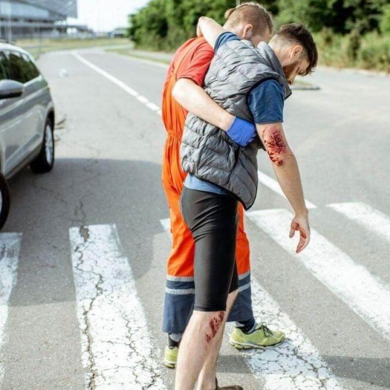 Man carrying child crossing street, illustrating pedestrian