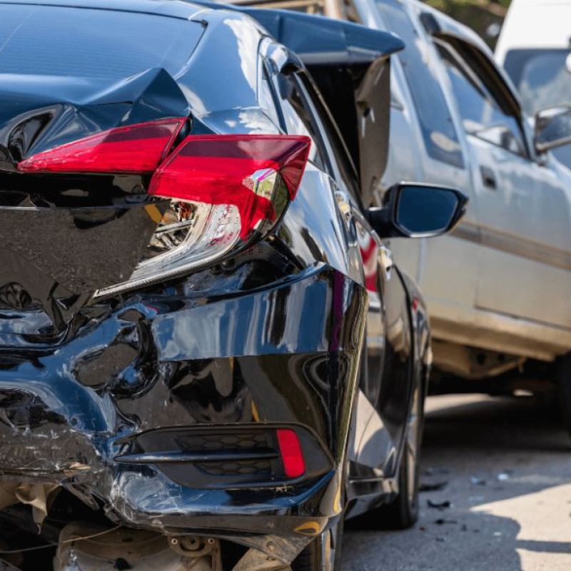 Car accident with three vehicles; rear-end collision causing damage to bumpers and taillights.