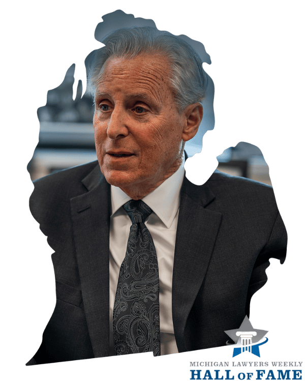 Man in suit with Michigan outline background, Michigan Lawyers Weekly Hall of Fame logo in corner.