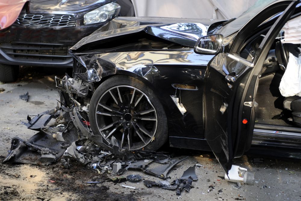 grey mustang with front end damage from a head on car accident
