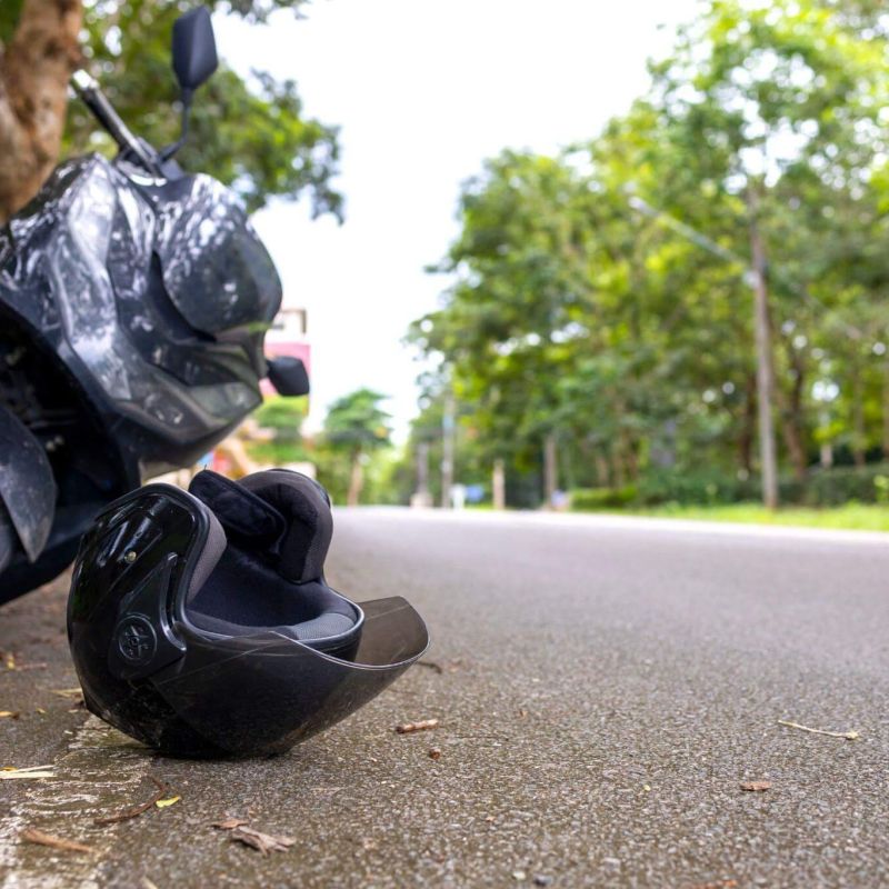 a motorcycle that is sitting on the side of the road after crashing