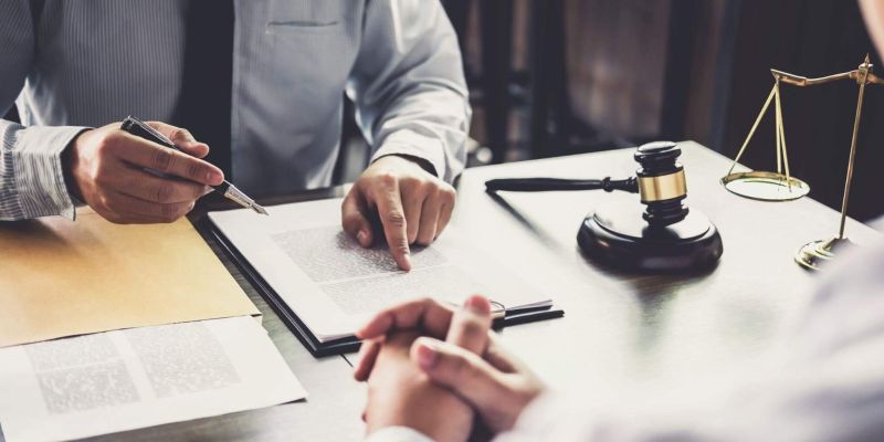two people sitting at a table in front of a judge