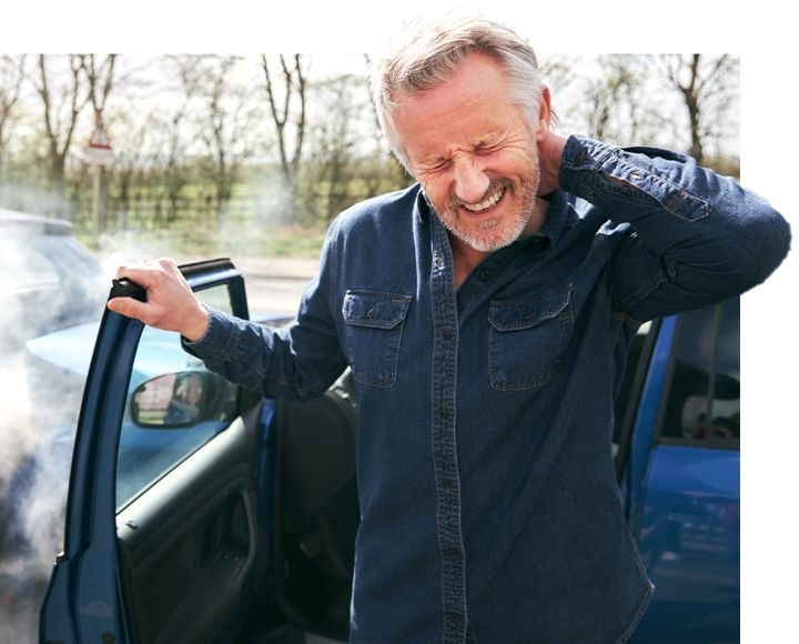 Man grimacing in pain, holding neck next to blue car; indicates possible whiplash or neck injury after accident.
