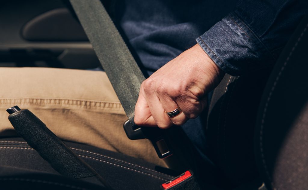 Man using seatbelt in a car