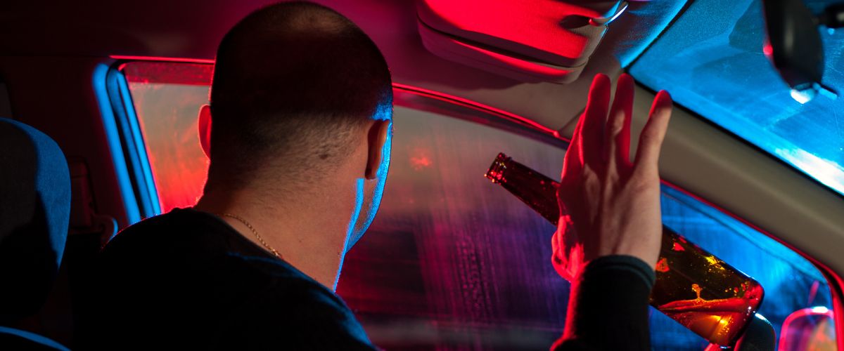 Man being pulled over at night by the police for drunk driving