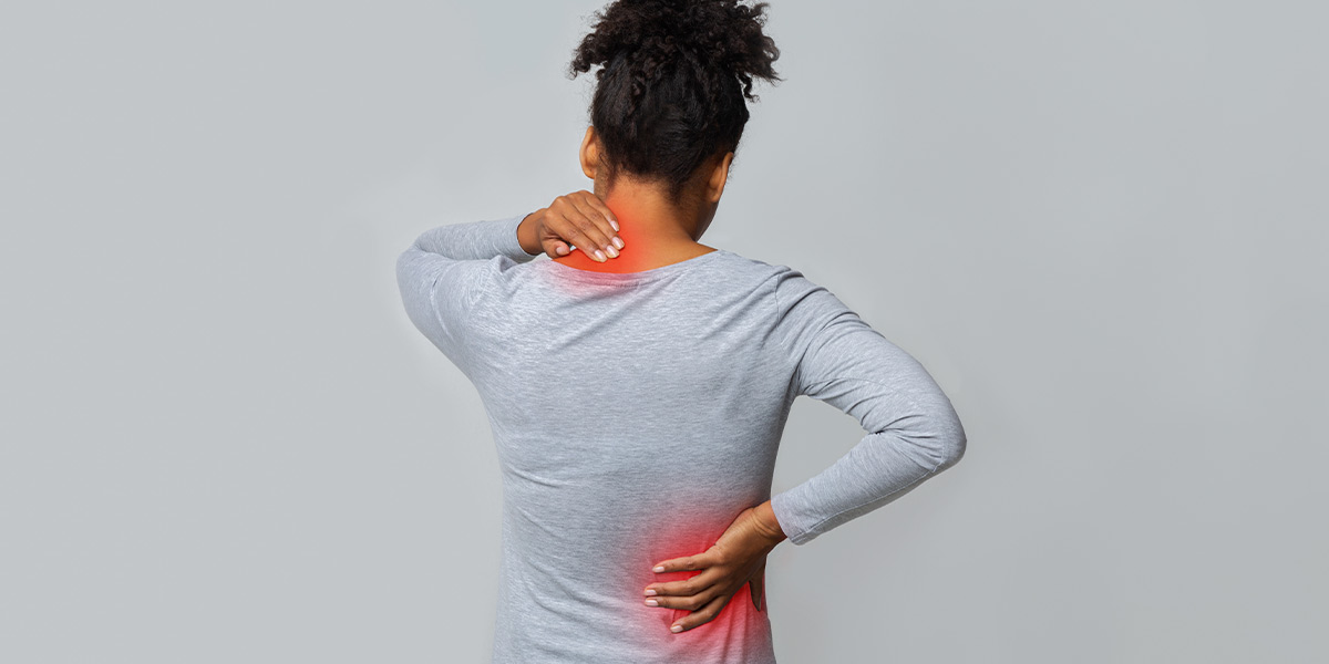 woman grabbing her back in pain