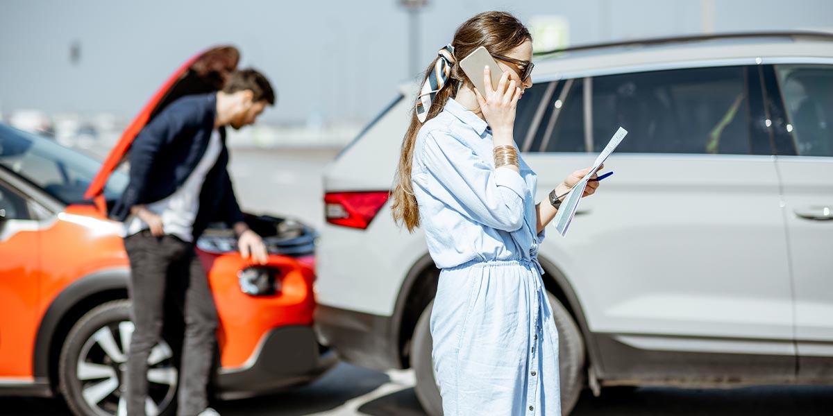 woman calling her insurance company after a rear end accident