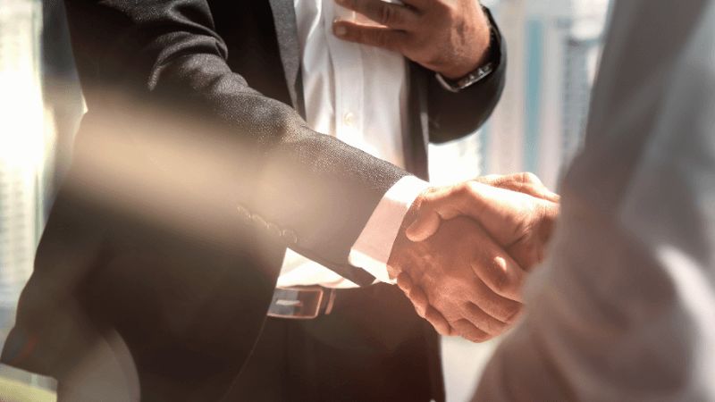 Lawyer shaking hands with his client after a case.