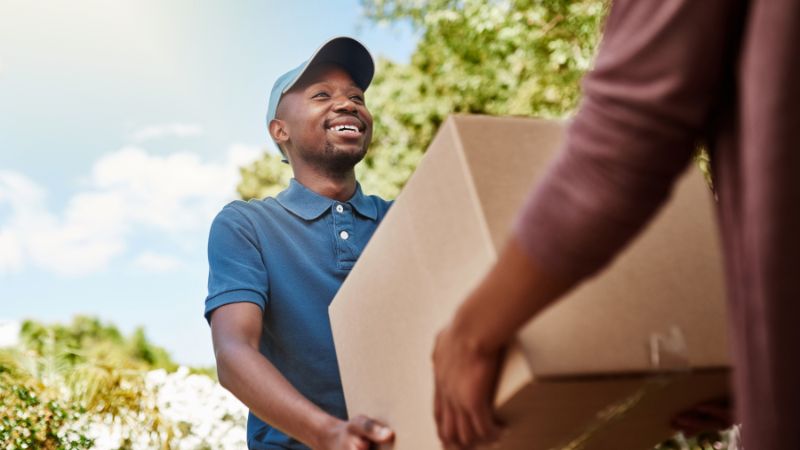 Postal worker delivering a package