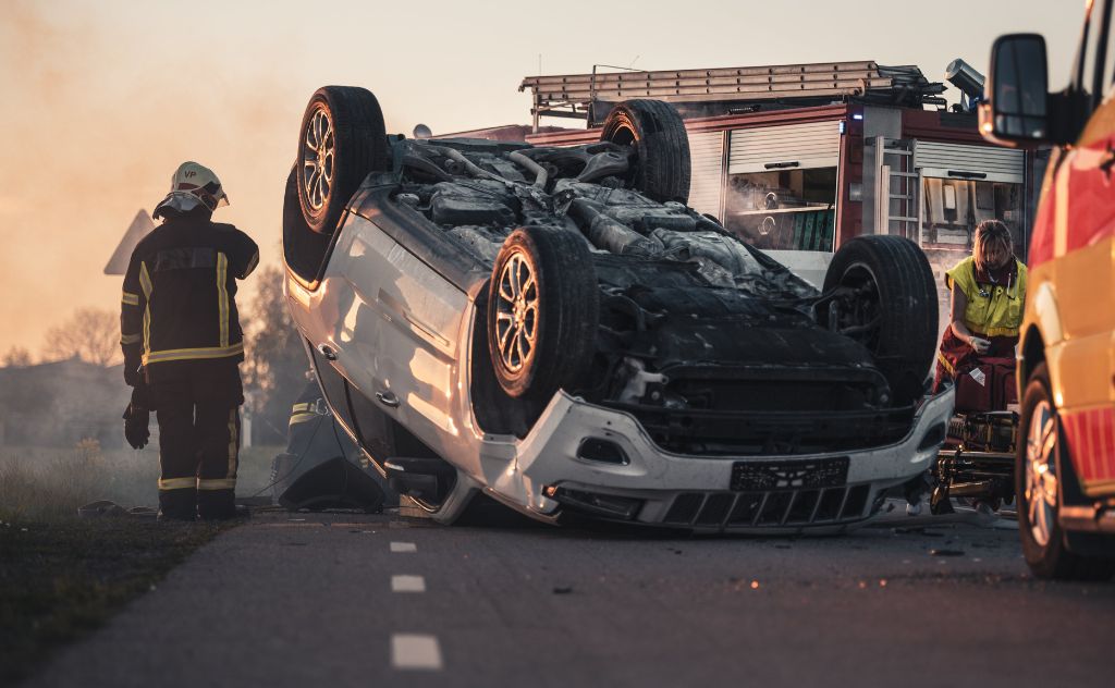 | Matz Injury Law firefighters next to upside down vehicle on road