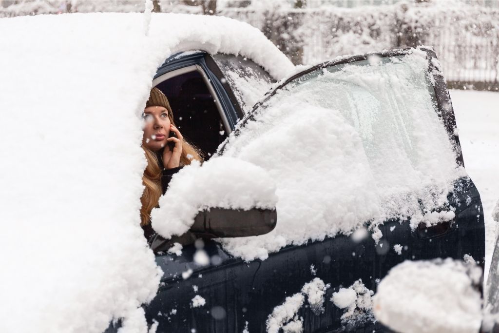 Matz Injury Law Representing Woman Stabbed by Mental Health Patient in Oakland County | Matz Injury Law Woman on the phone sitting in her car covered in snow