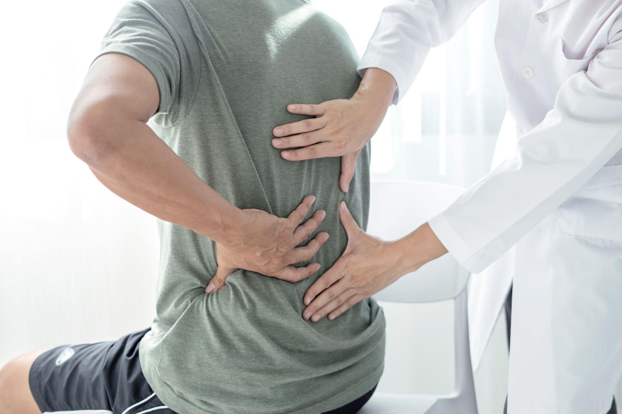 Dr examines low back injury