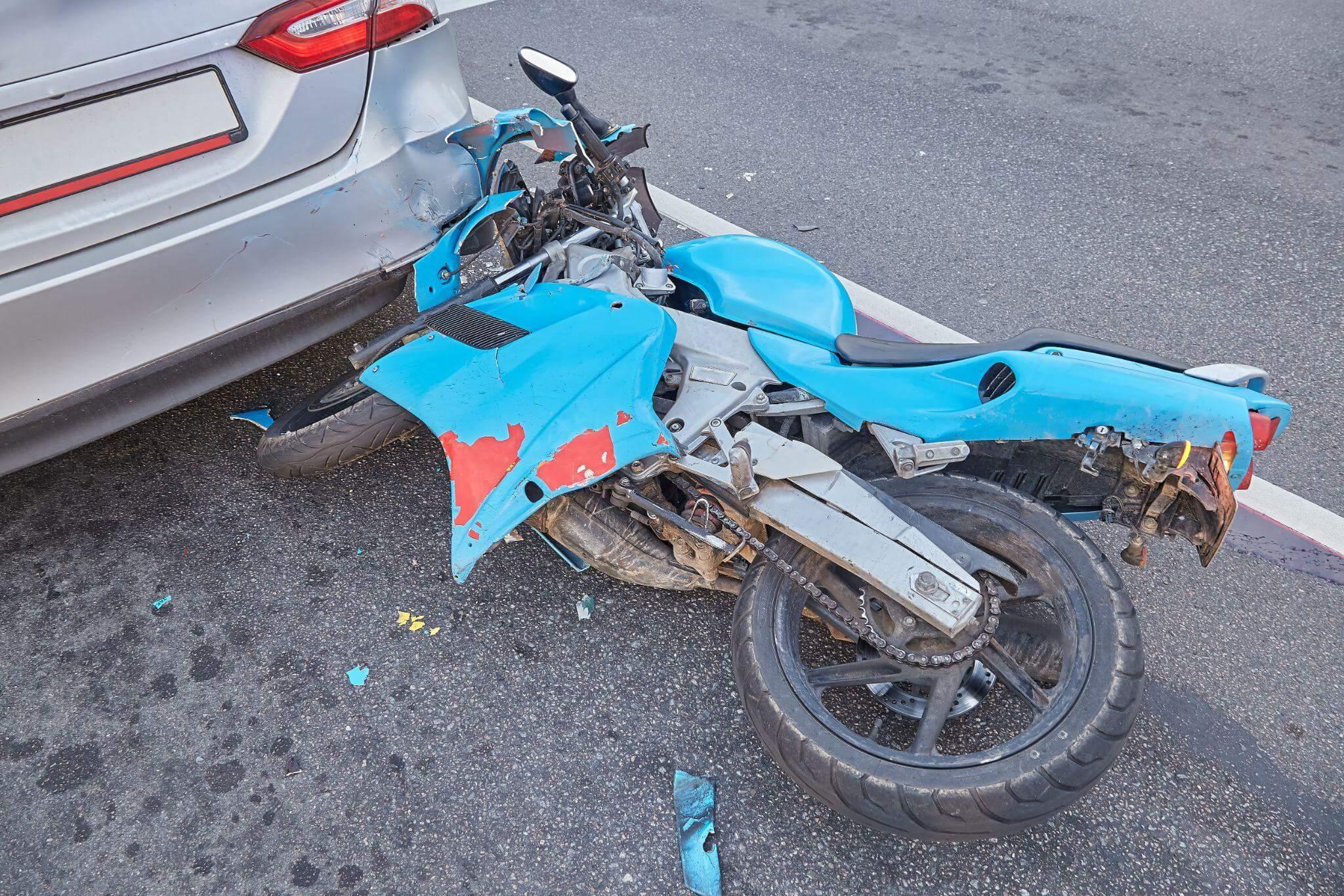 a blue motorcycle that is sitting in the street