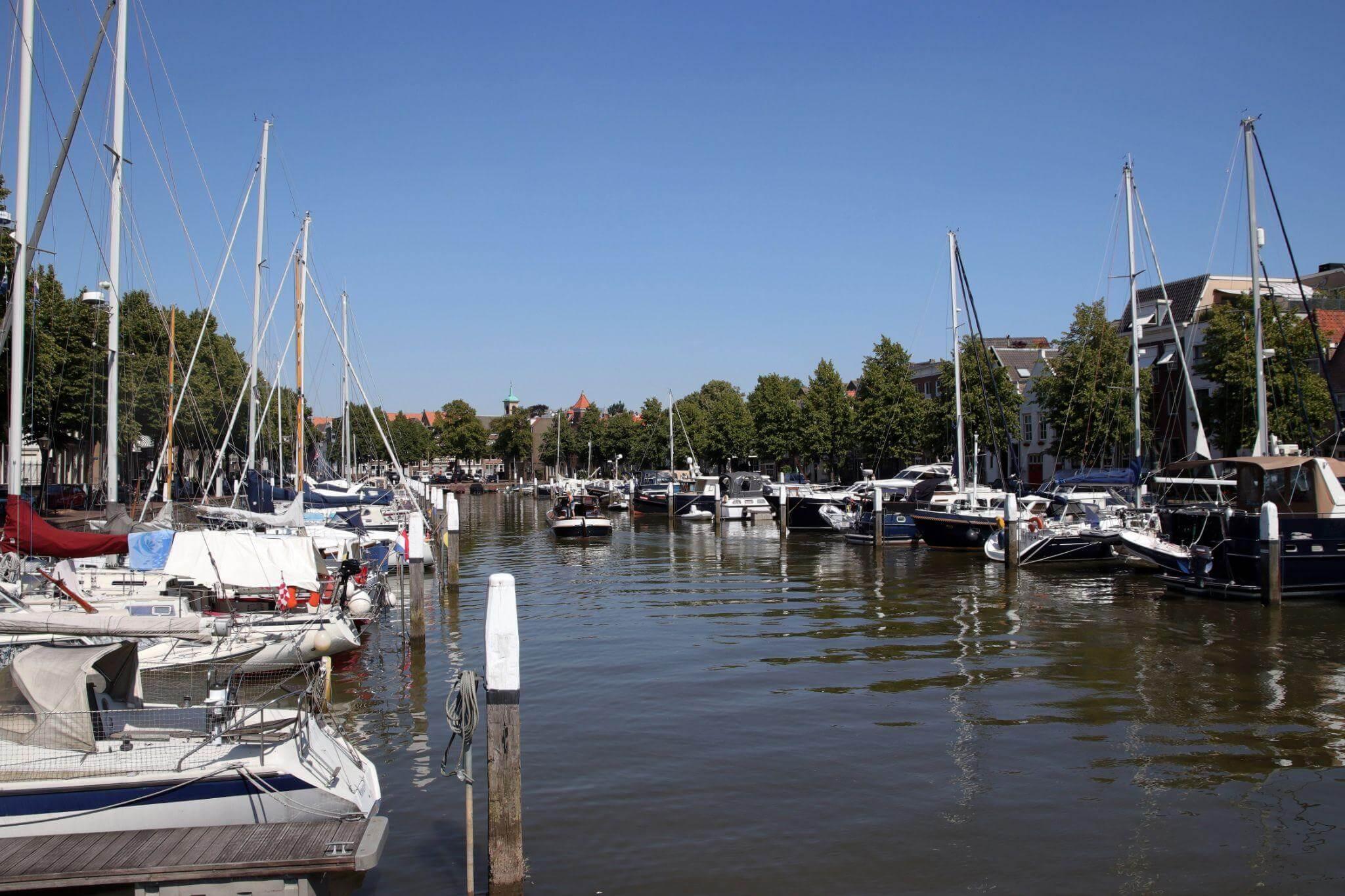 a harbor filled with lots of boats on a sunny day