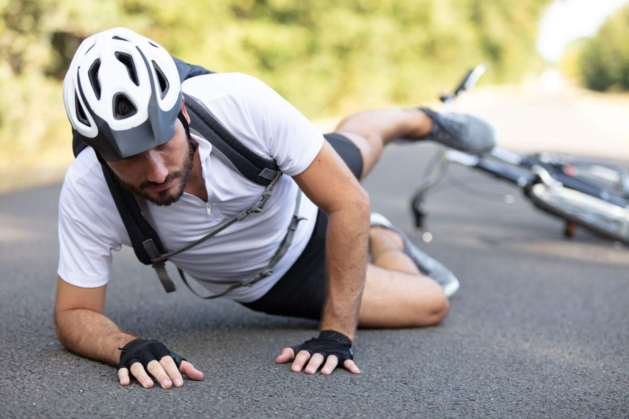 a man wearing a helmet is laying on the ground