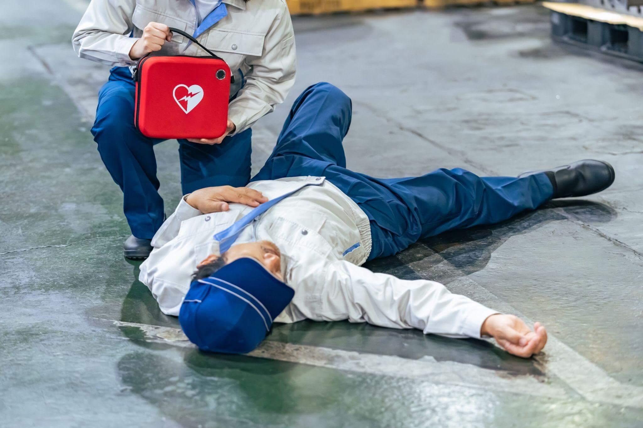 a person laying on the ground with a red suitcase