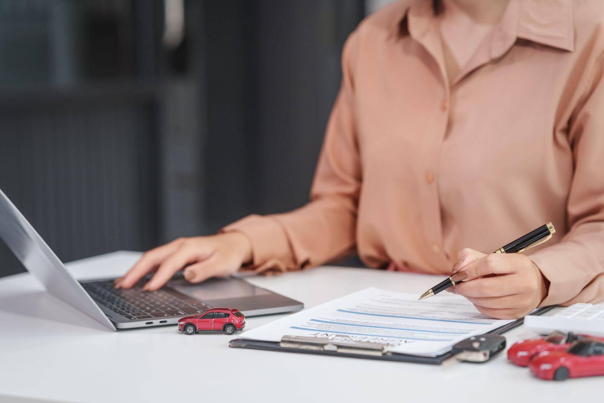 a woman sitting at a desk with a laptop computer