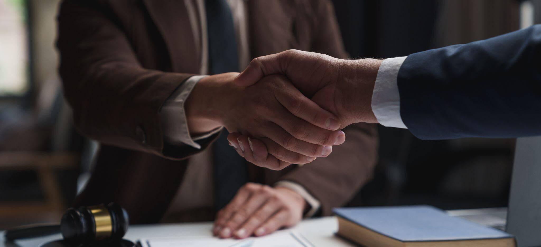 Handshake between two people discussing car accident involving a minor