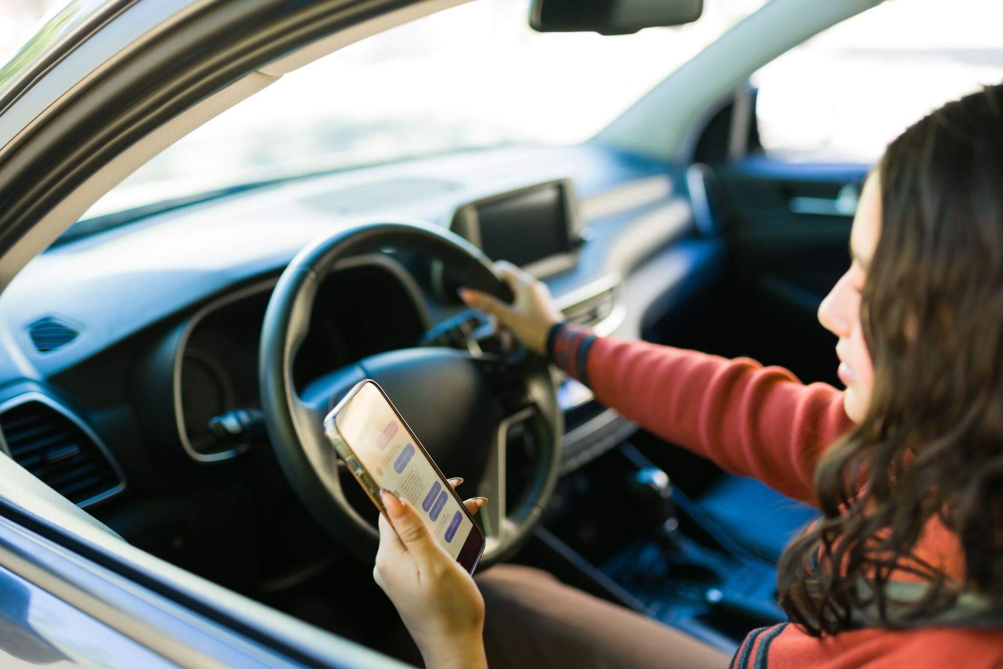 Woman driving while using cell phone