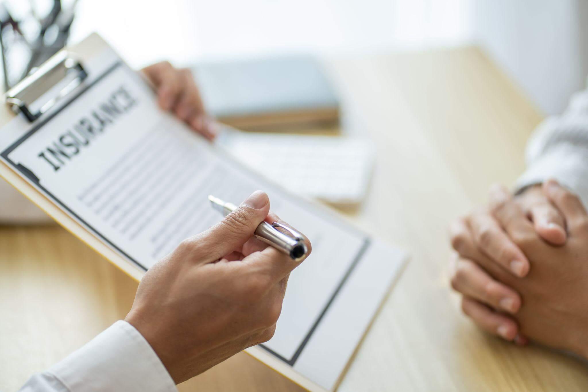 two people reviewing an insurance document