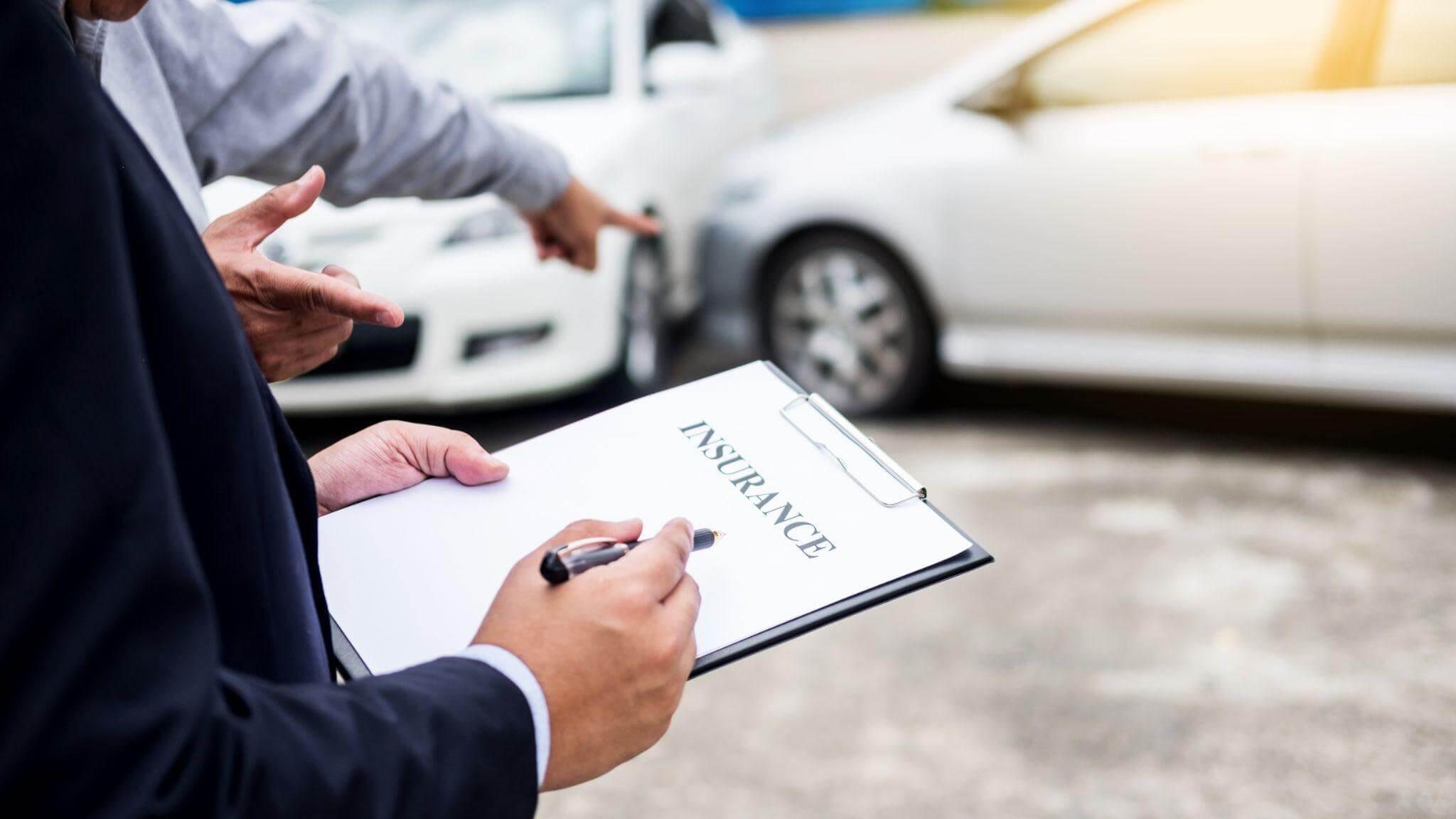 a man in a suit holding a clipboard in front of a car, the paper has the heading "insurance"
