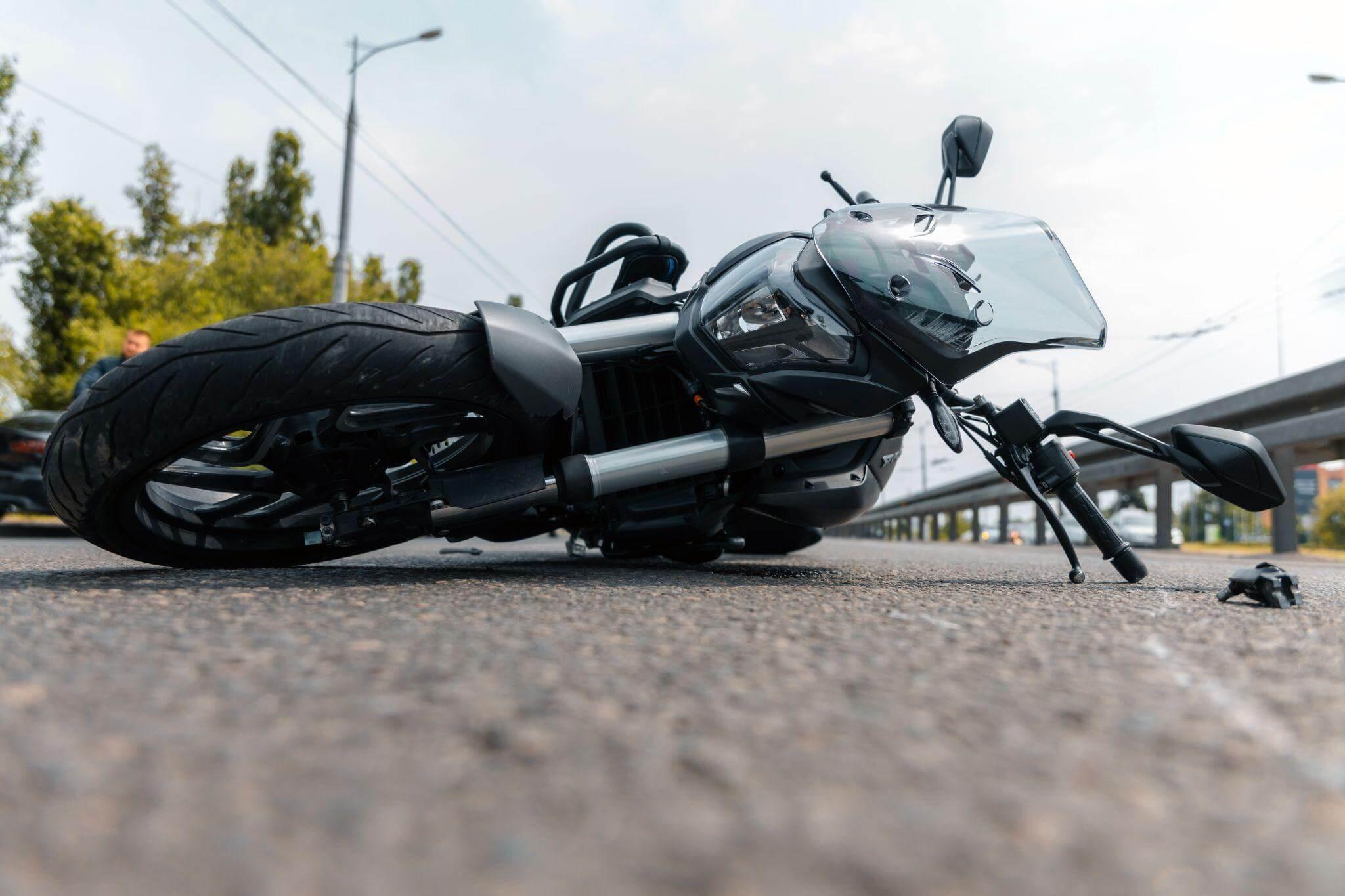 Black motorcycle by roadside after an accident