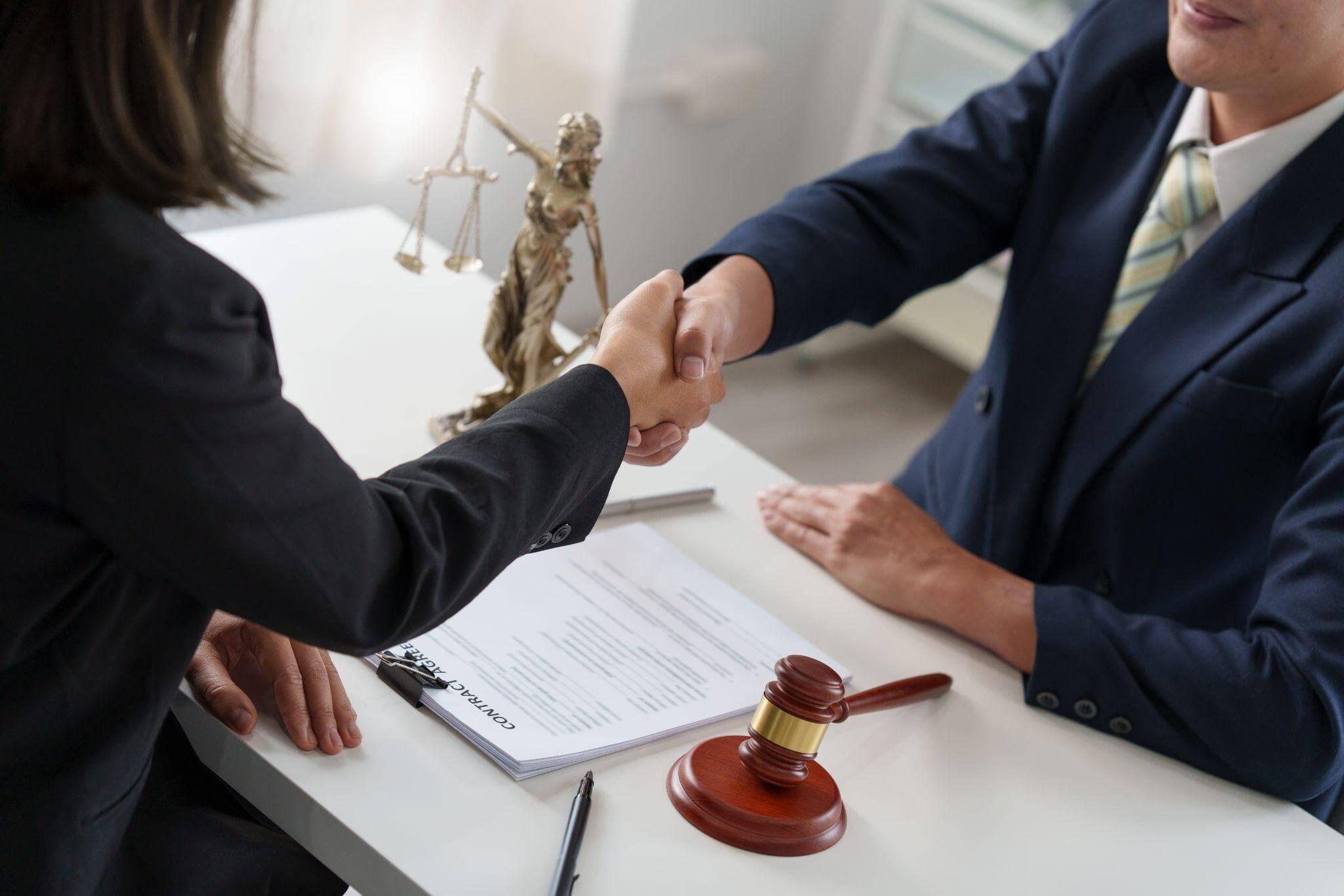Business meeting handshake between a woman and a man in a suit